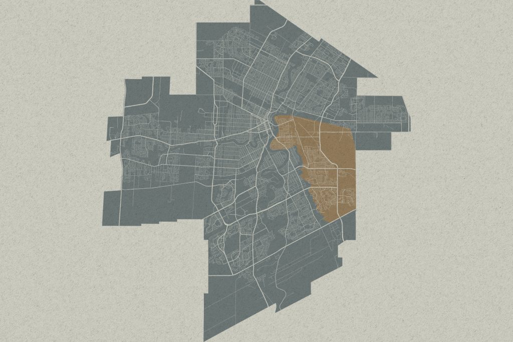Stylized city map with a highlighted brown district on the east side