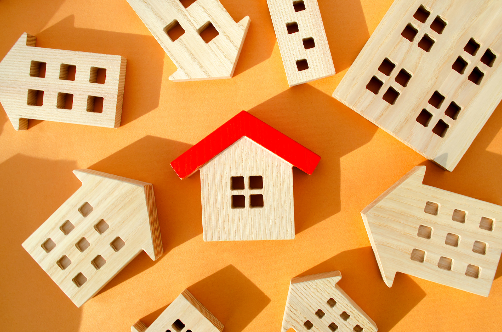 Many miniature wooden houses. Real estate concept. Choose affordable housing. Buying and selling housing. Market Analytics. Demand for housing. Rising and falling home prices. Population real estate management